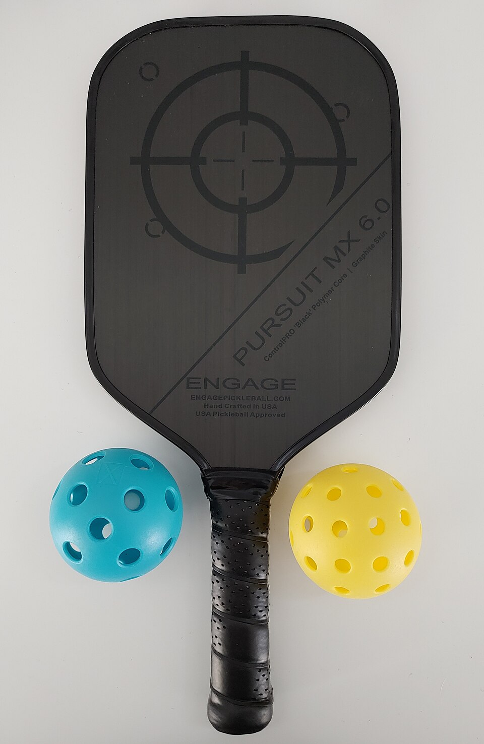 Pickleball paddle and ball ready for a serve